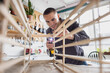 © ReeldealHD images - Young Happy Man putting together a piece of flatpack furniture
