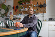 © ReeldealHD images - Young man taking a break whilst working from home in the kitchen