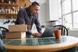 © ReeldealHD images - Focused man getting a parcel ready to ship