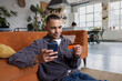 © ReeldealHD images - Man Shopping Online with Mobile and Card at Home
