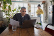 © ReeldealHD images - Young man looking at finances at home with a laptop