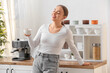 © Pixel-Shot - Happy young woman with cup of hot coffee in kitchen