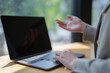 © Tj - Businesswoman talking during online meeting using laptop