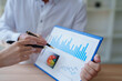 © Tj - Business people analysing financial data and growth report