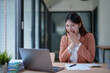 © Tj - Asian businesswoman laughing with surprise receiving good news