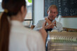 © Tj - Barista using sign language to communicate with customer in modern cafe
