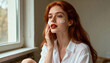 © Anna - Young redhead woman with freckles applying face cream. Natural beauty and skincare routine. Portrait of a girl using moisturizer for healthy skin