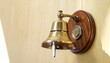 © Innovation - Brass wall bell with wooden base