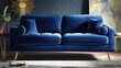 © Mii - Plush blue sofa with golden legs in a stylish room.