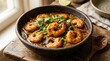 © Iqra - Flavorful shrimp curry served in a rustic bowl, garnished with fresh herbs and chili.