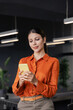 © Stock 4 You - Young Indian business woman manager ceo using cell phone mobile app. Smiling Latin Hispanic mature female businesswoman holding smartphone in office trading, reading, working online. Vertical