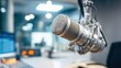 © StockHero - Large condenser microphone in professional podcast studio setup with blurred host in background