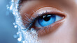 © syhin_stas - Close up of a woman's captivating blue eye showcasing artful winter makeup with shimmering blue eyeshadow and delicate frost like white eyelashes creating an icy beauty look