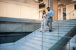 © Zoran Jesic - Business colleagues walking down office stairs talking and smiling