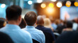 © Curioso.Photography - Audience attending a conference or seminar with focus on a speaker in a blurred modern event setting.