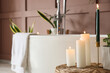 © Pixel-Shot - Table with burning candles in interior of bathroom, closeup