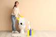 © Pixel-Shot - Young woman cleaning toilet bowl with brush near beige wall