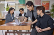 © Blue Jean Images - A team of colleagues is gathered for a meeting in the office