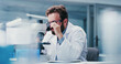 © peopleimages.com - Man, scientist or microscope with glasses in laboratory for medical research, investigation or exam. Male person, biotechnology or experiment with test for forensic study, clinic trial or results