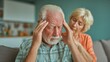 © Ryzhkov - Senior Man suffering from Headache and Stress while Wife comforts him at Home, Elderly Couple dealing with Health Issues and Pain in Living Room setting