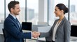 © Tiyur - Professional man and woman shake hands with smiles in a modern office environment