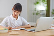© Blue Jean Images - A girl doing homework at home