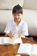 © Blue Jean Images - A girl doing her homework at her desk