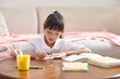 © Blue Jean Images - A girl doing her homework at her desk
