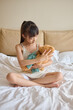 © Blue Jean Images - Girl dressing up her toy bear