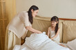 © Blue Jean Images - Mum and daughter ready for their nap