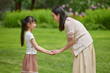 © Blue Jean Images - Mum and daughter holding hands and talking
