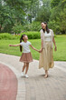 © Blue Jean Images - Mum and daughter strolling in a park
