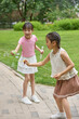 © Blue Jean Images - Two girls blowing bubbles in the park