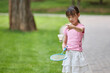 © Blue Jean Images - A girl plays badminton in the park