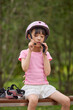 © Blue Jean Images - A girl puts on her protective gear for roller skating
