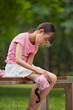 © Blue Jean Images - A girl puts on her protective gear for roller skating