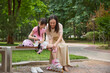© Blue Jean Images - Mother helps her daughter put on her protective gear for roller skating