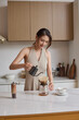 © Blue Jean Images - A beautiful woman making coffee by hand