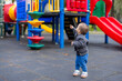 © leungchopan - Little boy playing happily at children park outdoors