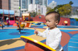 © leungchopan - Happy baby playing at children park outdoor playground