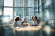 © Microstocke - Blurred Professional team collaborating in modern office meeting