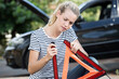 © auremar - woman and broken down car with warning triangle