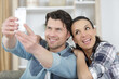 © auremar - couple at home taking a selfie