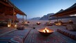 © tynza - High end stock image of a traditional Bedouin tent camp at twilight, patterned carpets, low cushions, glowing fire pit, desert silence, immersive hospitality concept