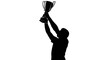 © Quensha - Man holding up a trophy cup.