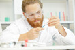 © auremar - scientist attaching a disposable tip to a micropipette