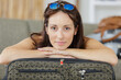 © auremar - portrait of woman leaning on her suitcase