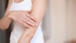 © MdApel - Woman applying moisturizer to her arm skin care routine