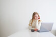 © Olga - Thoughtful woman working on laptop at home. Online work, decision making and focused productivity concept with copy space.