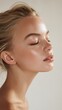 © Newleks - Young woman with closed eyes finding peace and relaxation, highlighting clear and healthy skin, showing natural beauty, wellness, and self care in a profile view